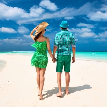 Couple in green on a tropical beach at Maldives