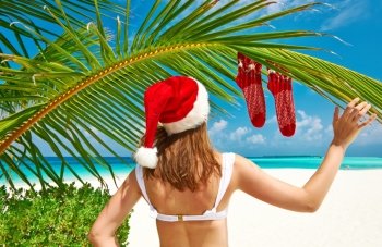 Woman in bikini on a tropical beach at christmas