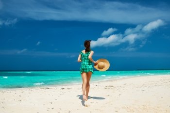 Woman in green dress at tropical beach