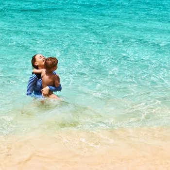 Mother and her little son at the tropical beach