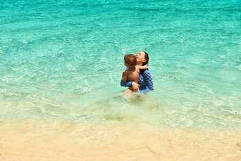 Mother and her little son at the tropical beach