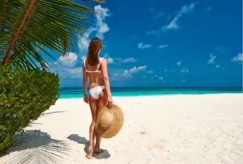 Woman in bikini on a tropical beach at Maldives