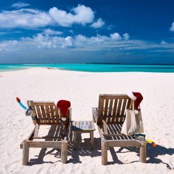 Beautiful beach at Maldives with chaise-lounges at christmas