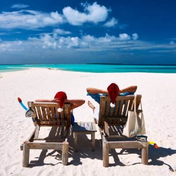 Couple relax on a tropical beach at christmas
