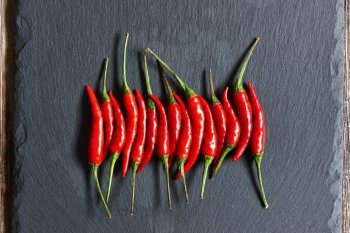 Red hot chili peppers on slate background 
