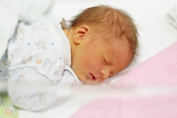 Three days old newborn baby in bed 