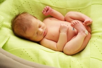 One week old newborn baby in cocoon 