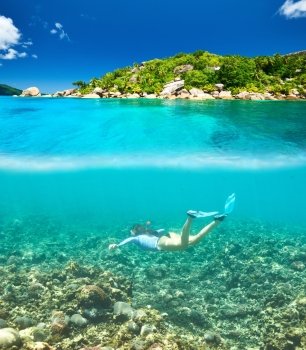 Woman with mask snorkeling in clear water at Seychelles