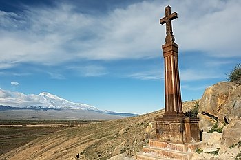Christian cross in ancient monastery Khor Virap near Turkish-Armenian border in front of Ararat mountain