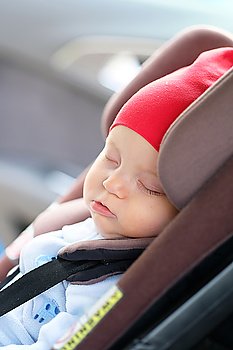 Six months old baby sleeping in car seat
