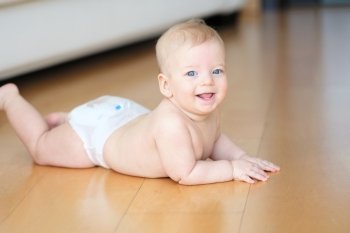 Six months old baby crawling on floor