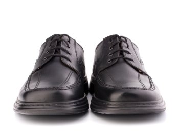 Black glossy man’s shoes with shoelaces isolated on white background