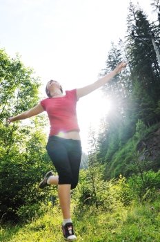 happy girl jump in air outdoor in nature