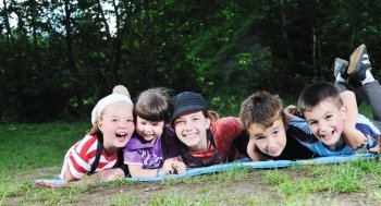 happy children group  have fun outdoor in nature at suny day