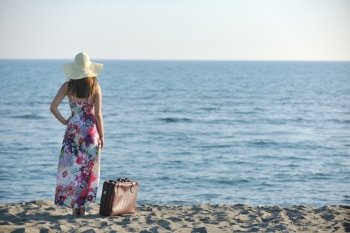 woman with suitcase travel bag  on the beach  representing exotic and luxury escape and freedom