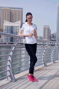 Young beautiful  woman jogging and running  on morning at  park in the city. Woman in sport outdoors health and fitness concept