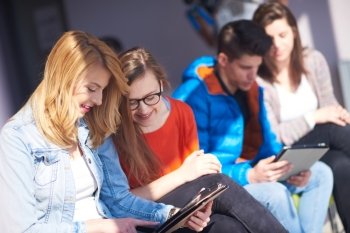 students group working on school  project  together on tablet computer  at modern university