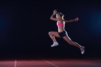 Athletic woman running on athletics race  track