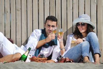 happy young couple enjoying  picnic on the beach and have good time on summer vacations
