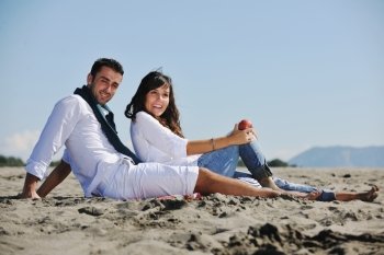 happy young couple enjoying  picnic on the beach and have good time on summer vacations