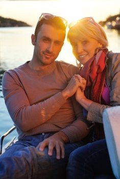 happy young couple in love  have romantic time at summer sunset   at ship boat while  representing urban and countryside fashin lifestyle