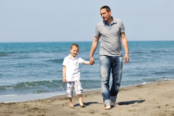 happy young  father and son have fun and enjoy time on beach at sunset and representing healthy family and support concept