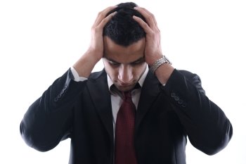 Portrait of a young business man looking depressed from work isolated over white background in studio