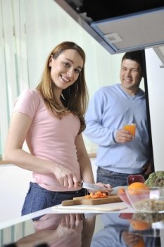 happy young  woman with apple in kitchen and other food and vegetables