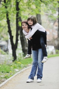 happy oung mother and daughter have fun outdoor 