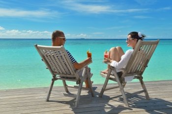 happy young couple relax and take fresh drink at summer vacation