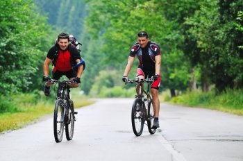 two friends have fun outdoor in nature and representing concept of  healthy life and fitnes on muntain bike