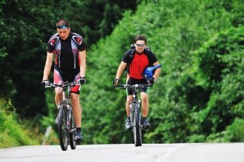 two friends have fun outdoor in nature and representing concept of  healthy life and fitnes on muntain bike