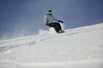 snowboard woman racing downhill slope and freeride on powder snow at winter season and sunny day