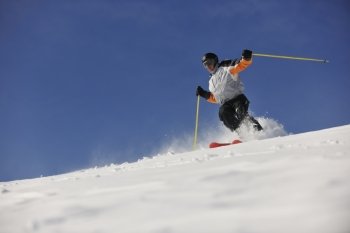 man ski free ride downhill at winter season on beautiful sunny day and powder snow