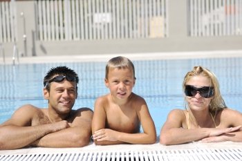 happy young family have fun on swimming pool  at summer vacation