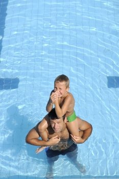 happy father and son have fun at swimming pool
