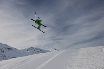 extreme freestyle ski jump with young man at mountain in snow park at winter season