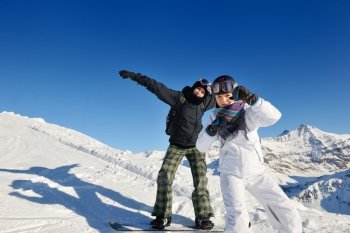 happy people group have fun on ski snow at winter season on mountain with blue sky and fresh air