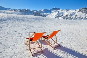 chair on top of mountain range at winter season sunny day with blue sky in background representing concept of relax