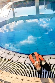 Scuba on the edge of outdoor swimming pool