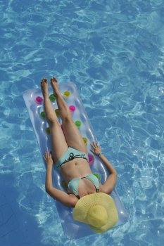 happy young woman relax at swimming pool at vacation travel resort 