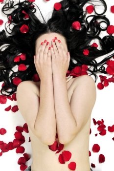 beautiful young nude woman with roses isolated on white representing beauty concept