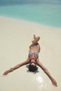 beautiful and happy young woman on beach have fun and relax on summer vacation  over the crystal clear sea