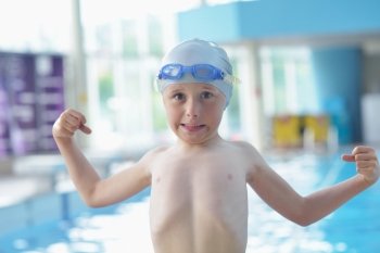 happy little child portrait on swimming school classes and recreation at indoor pool