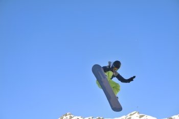 jumping freestyle skier at mountain with fresh snow fresh sunny winter day