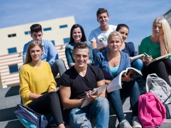 Group portrait  of happy  students outside sitting on steps have fun