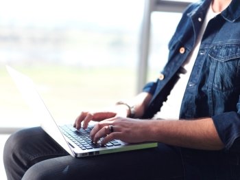 student working on laptop computer at university school modern interior