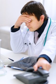 Sitting at office upset medical doctor just had bad phone call
