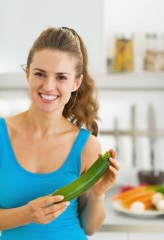 Happy young woman with fresh zucchini