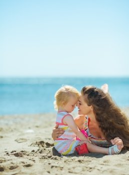 Mother and baby girl playing on beach